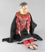 A Native American doll, with composition head, kid leather hands and beadwork borders to costume,