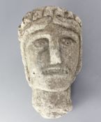 A 12th century Norman limestone head of a man or saint, height 11.75in.Provenance: believed to