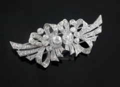 A 1940's/1950's white gold? and diamond double clip brooch, of scrolling ribbon bow design and set