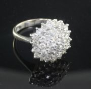 An 18ct white gold and diamond cluster ring, of dome top shaped hexagonal form, size N.From the