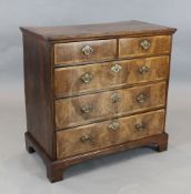 A George II crossbanded walnut chest,, of two short and three long drawers, W.3ft D.1ft 8in. H.2ft