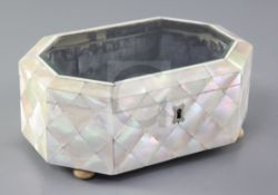 A Victorian mother of pearl clad jewellery casket, with bevelled glazed lid and ivory bun feet,