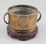 A rare Chinese Ming cylindrical bronze censer, 16th / 17th century, the body applied with a pair