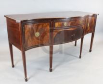 A George III crossbanded mahogany serpentine sideboard, with central drawer and tambour