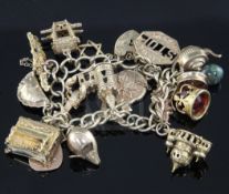 A 9ct gold charm bracelet hung with seventeen assorted charms, including piano, cornish pasty and