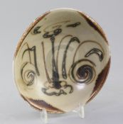 A Chinese Sancai dish, Tang dynasty, decorated with dashes and scrolls reminiscent of a face,