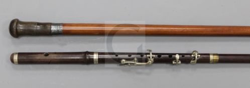 A rosewood walking stick with 'flute' handle, 35.5in., and a horn knopped malacca cane, 34.5in.