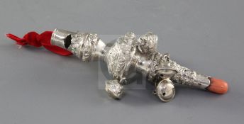 A William IV embossed silver child's rattle with coral teether, by Unite & Hilliard, hung with six