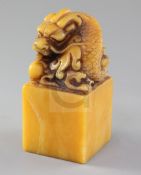 A Chinese shoushan stone seal, the top carved with a dragon with pearl, four character matrix,