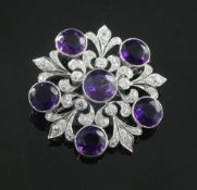 An attractive Tiffany & Co white gold?, amethyst and diamond flower head pendant brooch, set with