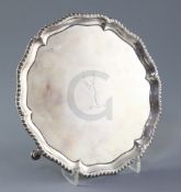 A George III silver salver by Richard Rugg, of shaped circular form, with gadrooned border and
