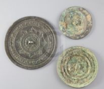 Three Chinese bronze mirrors, Tang dynasty or later, the largest cast in relief with inscription