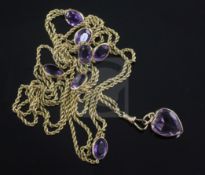 An early 20th century gold and amethyst set guard chain, set with seven oval cut amethysts, together