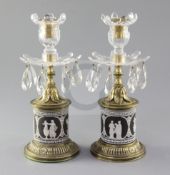 A pair of early 19th century ormolu mounted black jasperware lustre candlesticks, with cut glass