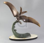 Lucien Gibert. A patinated bronze model of a seagull flying over a wave, signed Trebig, height