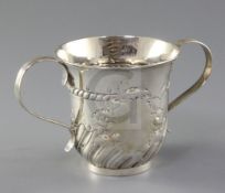 An early George III repousse demi fluted silver porringer by Fuller White, with vacant cartouche and