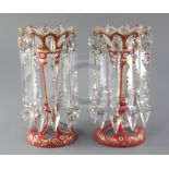 A pair of Bohemian pink and white overlaid cut glass lustres, with gilt decoration and spear