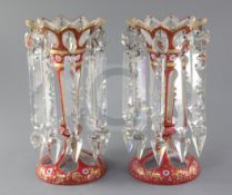 A pair of Bohemian pink and white overlaid cut glass lustres, with gilt decoration and spear