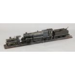 A scratchbuilt model of a 262 steam powered locomotive and tender, length 37in., and a similar model