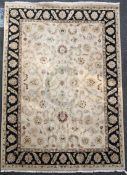 A Tabriz style carpet, with field of palmette scrolls on a beige ground, 12ft 2in. x 9ft 1in.