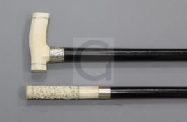 An ebonised cane, with a Chinese relief carved ivory handle, inset with portrait, 39.5in., and an