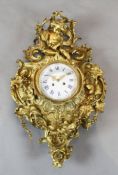 A third quarter of the 19th century French ormolu cartel clock surmounted by a Bacchanalian