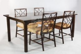 A mid to late 20th century mahogany extending dining table and ten chairs, the table with chevron