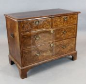 An early 18th century featherbanded walnut chest, of two short and two long drawers, W.3ft 6in. D.