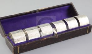 A cased matched set of six Victorian silver napkin rings, with engraved decoration, William Evans(2)