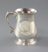 A George II silver baluster mug, with acanthus leaf capped scroll handle, W?, London, 1751, 12.