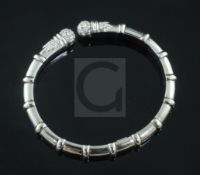 An Italian 18ct white gold and diamond set open bangle, of ribbed design.