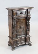 A 17th century Italian walnut small cupboard, with frieze drawer and central door flanked by