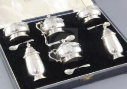 A cased 1930's six piece silver condiment set by Z. Barraclough & Sons, with decorated borders,