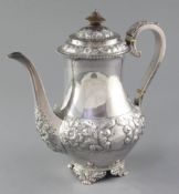A Victorian embossed silver baluster coffee pot by Charles Stuart Harris, with engraved monogram and