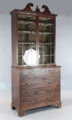 A George III mahogany secretaire bookcase, with swan's neck pediment and astragal glazed doors,