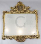 A late Victorian giltwood and gesso wall mirror, with ornate pierced scroll flower and dragon