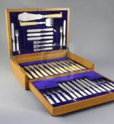 A George V silver service in oak fitted case, comprising twelve pairs of mother of pearl handled