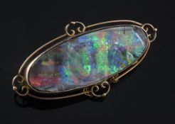 An Edwardian 9ct gold and black opal brooch, of oval form, the opal length approximately 41mm,