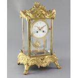 A late 19th century French ormolu mounted four glass clock, Planchon, Paris, with rocaille work