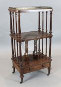 A Victorian figured walnut three tier whatnot, with base drawer, W.1ft 10in. D.1ft 4in. H.3ft 7in.