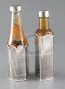 Two modern Theo Fennell silver sauce bottle holders and lids, for HP Sauce and Heinz Ketchup, with
