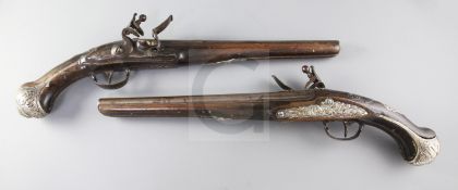 A pair of Turkish silver mounted mahogany flintlock pistols, circa 1800, showing traces of