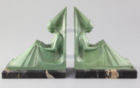 Max Le Verrier. A pair of green patinated bronze bookends, modelled as seated medieval maidens