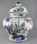 A massive 19th century Kangxi style Chinese wucai baluster jar and cover, painted with a