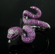 A modern blackened? gold, diamond and ruby encrusted serpent ring, size N.