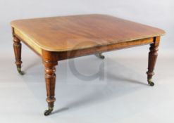 A Victorian mahogany extending dining table, with rounded rectangular top and three leaves, on