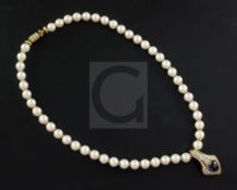 An 18ct gold, cultured pearl necklace with heart shaped cabochon sapphire and baguette and round cut