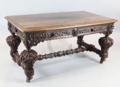 A Victorian carved oak library table, in the manner of Richard Bridgens, with two frieze drawers,