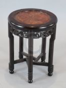 An early 20th century Chinese hardwood occasional table, with burr wood inset top and lotus carved