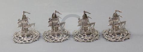 A set of four Edwardian novelty silver menu holders, modelled as galleons, by James Dudley,